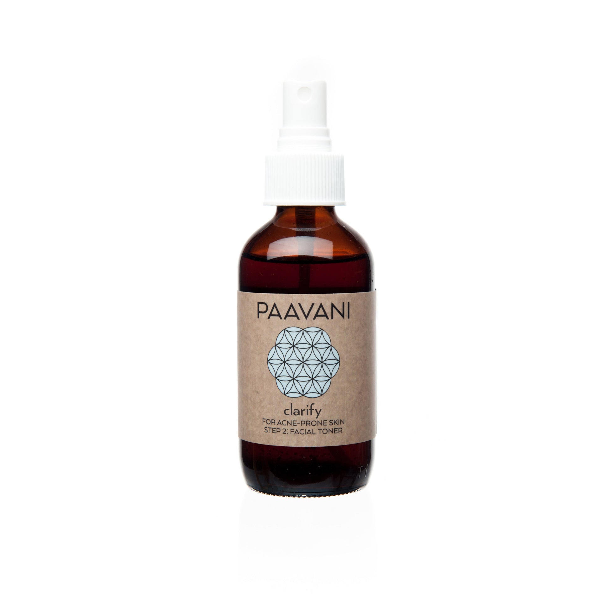 A brown glass bottle with a white spray nozzle labeled 'PAAVANI clarify' containing a clarifying toner with Neem and Rose.