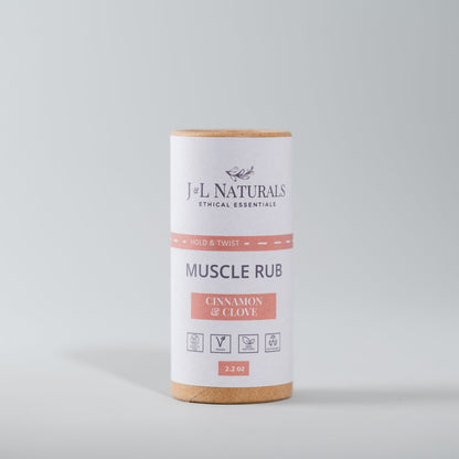 A push-up tube packaging of J+L Naturals muscle rub balm with label indicating cinnamon and clove flavors for soothing joint and muscle discomfort.